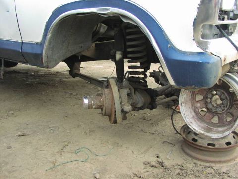 1981 Ford Bronco - Close-up of the front wheel assembly and fender of a 1978 Ford Bronco, showing its suspension and braking system.