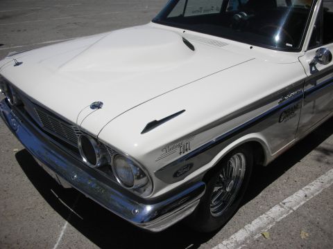 1992 Ford Crown Victoria - A white 1964 Ford Fairlane with a prominent hood scoop and racing stripes is parked outdoors.
