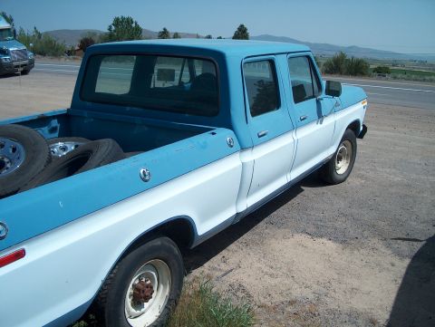 1978 Ford Bronco - Side view of a two-tone 1978 Ford F-250 Crew Cab pickup truck parked on a dirt shoulder.