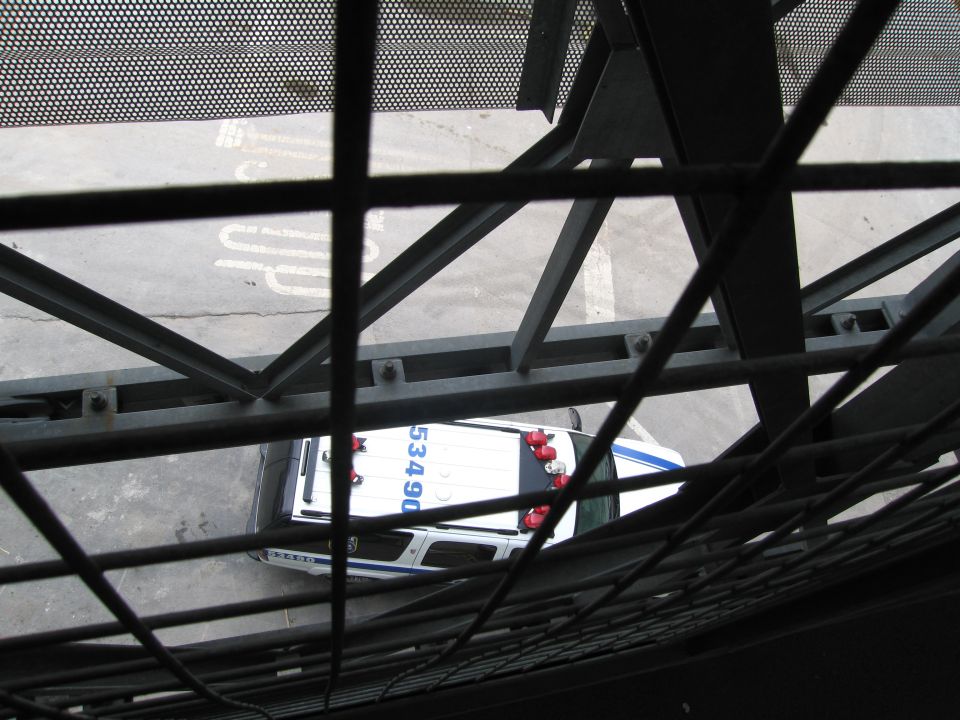 Police car seen from above through a metal grating, marked 5340