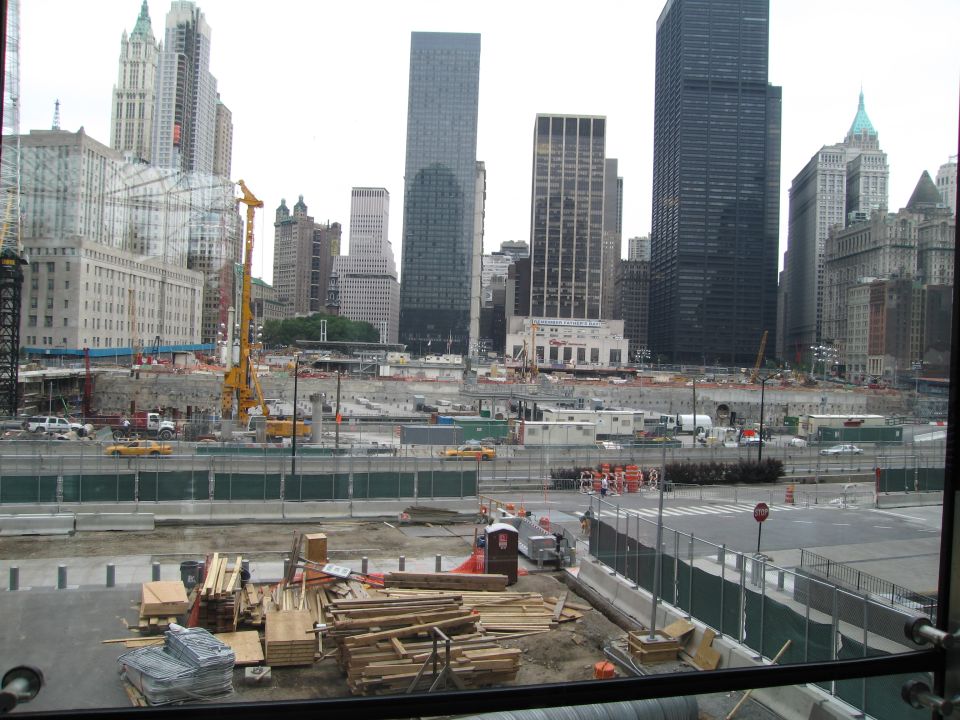 City construction site with lumber in the foreground and skyscrapers behind