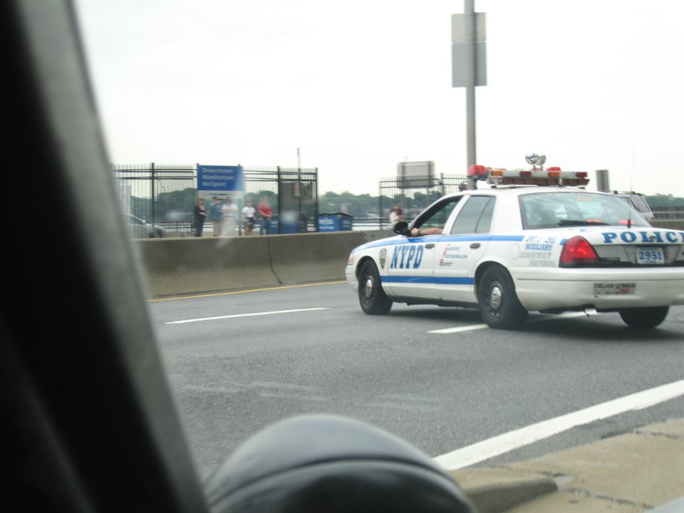White NYPD Ford Crown Victoria police car on a highway