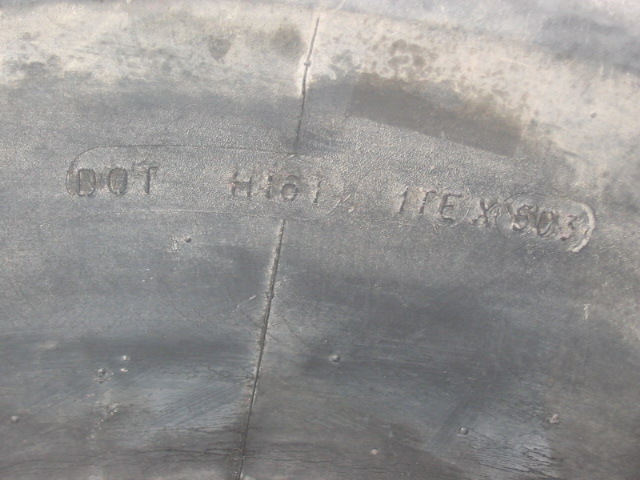 Close-up of tire sidewall showing DOT markings and size information