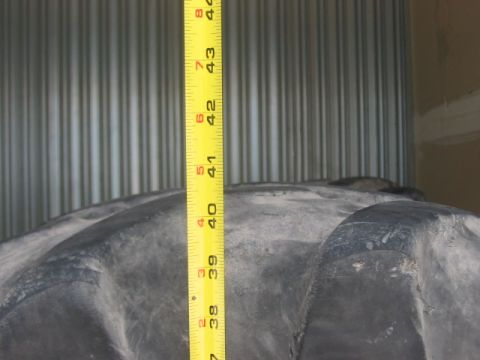 1991 Ford Bronco - A measuring tape is placed against a large tire, indicating its size.