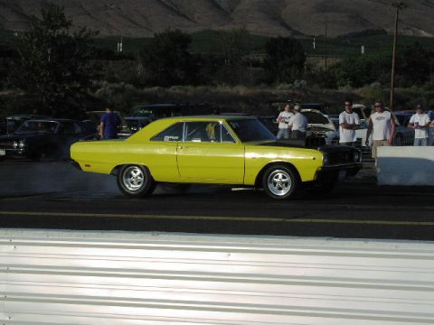 1981 Ford Bronco - A bright yellow 1967 Dodge Dart with a black hood sits on the drag strip, ready for action.