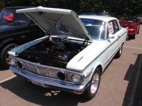 1989 Ford Mustang - This 1962 Ford Falcon is displayed with its hood open, revealing the engine bay.