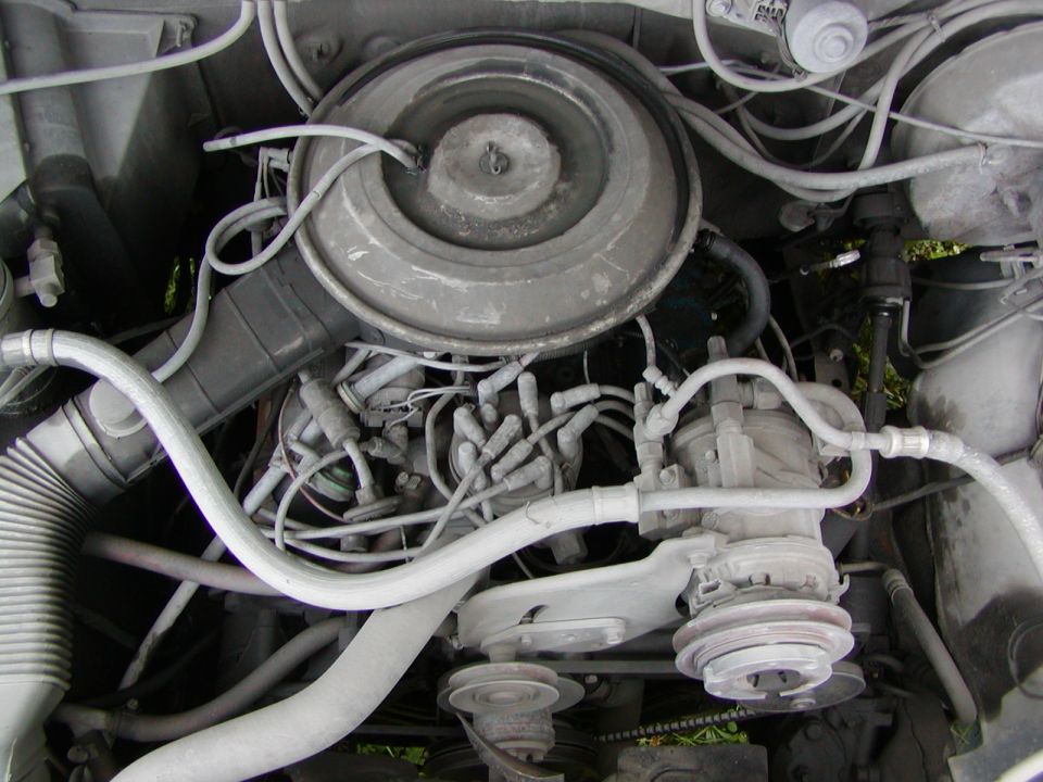 Engine bay with air cleaner and components painted in silver primer or paint