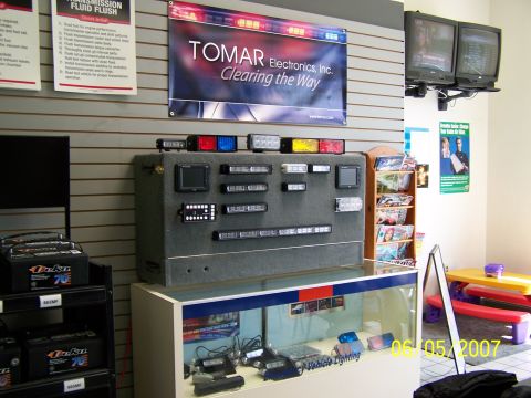 2003 Ford Crown Victoria - A display of various emergency vehicle lights and related equipment is shown in a store setting.