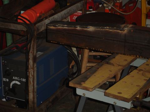 1989 Ford Bronco - A welding machine and a metal beam are visible in a workshop setting.