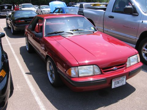 1989 Ford Mustang - Red 1989 Ford Mustang coupe parked at an outdoor event.