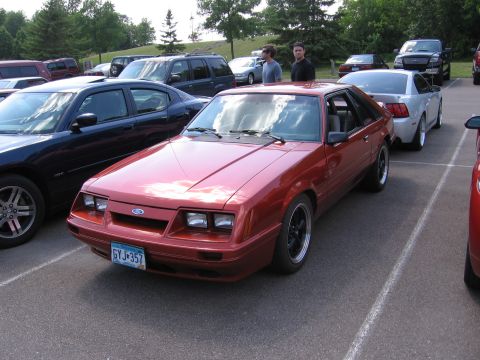 1989 Ford Mustang - This 1989 Ford Mustang coupe is parked in a lot, with other vehicles visible around it.