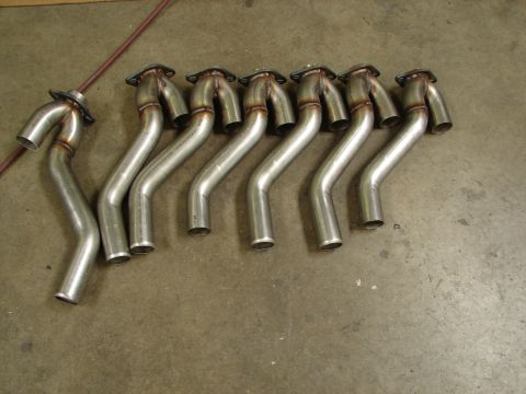 1992 Ford Taurus - A set of exhaust Y-pipes, likely for a performance application, are laid out on a concrete floor.