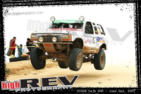 1992 Ford Explorer - This modified truck is airborne during a race, its custom suspension and racing livery.