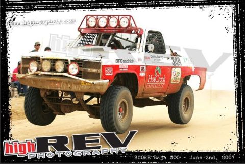 1992 Ford Explorer - This off-road racing truck features a prominent roof-mounted light bar and BFGoodrich tires, competing in what appears to be a desert race.