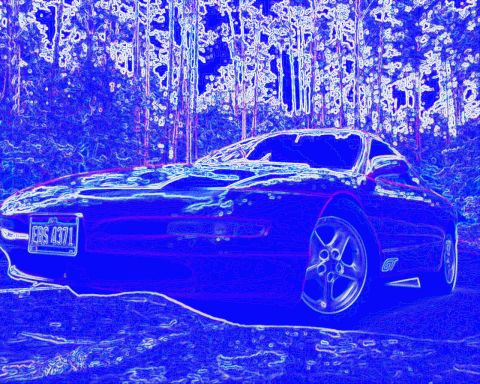 1993 Ford Probe - A 1993 Ford Probe GT is parked outdoors with trees in the background. The license plate is visible.