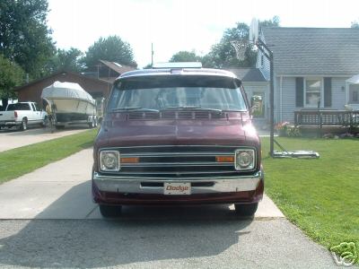 1978 Ford E250 - Maroon Dodge van parked in a driveway with a house and basketball hoop in the background.
