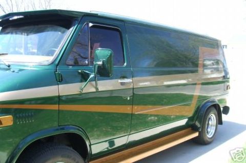 1978 Ford E250 - This 1978 Ford E250 van features a two-tone green and tan paint scheme with wood paneling along the lower body.