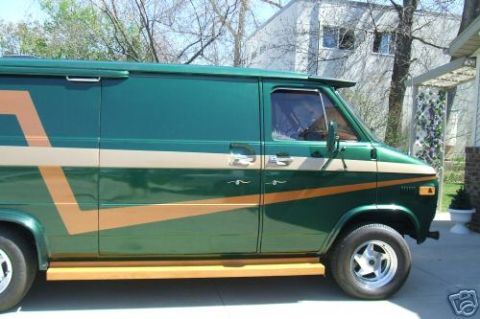 1978 Ford E250 - Side view of a 1978 Ford E250 van, painted green with a tan stripe and wood trim along the bottom.