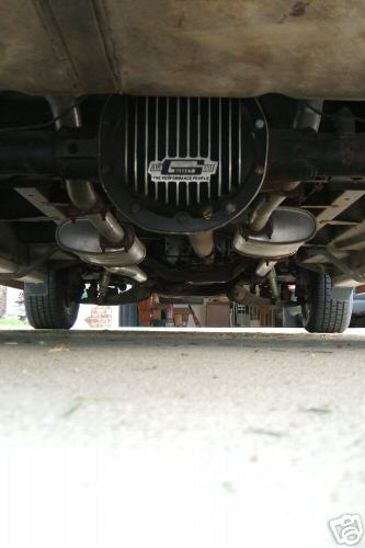 1978 Ford E250 - Underside view of a vehicle's rear differential and exhaust system, with a "G-Force" branded cover.