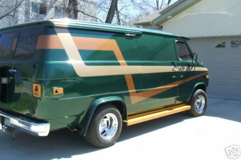 1978 Ford E250 - This van has a distinctive stripe pattern on its side, with wooden running boards.