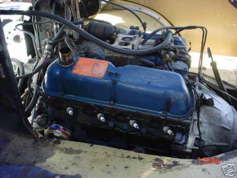 1978 Ford E250 - Close-up view of a Ford V8 engine, showing the valve covers and spark plugs.