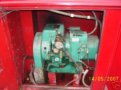 1978 Ford E250 - A generator unit is visible within a red compartment, with visible hoses and wiring.