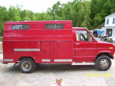 1978 Ford E250 - This 1978 Ford E250 utility truck features a custom box body with multiple storage compartments and dual rear wheels.