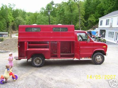 1978 Ford E250 - This 1978 Ford E250 utility truck features a custom red box body with multiple compartments.