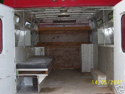 1978 Ford E250 - The interior of a van shows a basic sleeping area and storage shelves, with a date stamp from 2007.