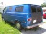 1978 Ford E250 - A blue panel van with black rear doors sits parked on a grassy area.