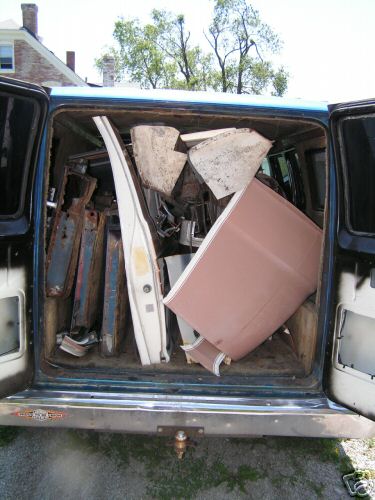 1978 Ford E250 - Van interior filled with assorted automotive parts, obscuring the view of the vehicle itself.