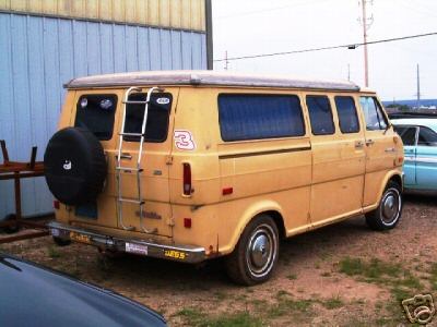 1978 Ford E250 - Rear view of a 1978 Ford E250 camper van, equipped with a ladder and external spare tire.