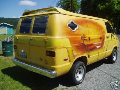 1978 Ford E250 - A yellow full-size cargo van shown from the rear three-quarter angle, featuring a custom airbrushed sunset/landscape mural on the rear and…