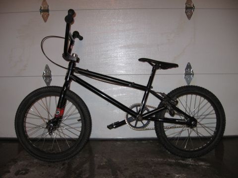 1997 Ford Probe - A black BMX bicycle is parked in front of a garage door.