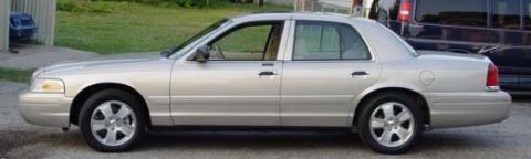 1996 Ford Crown Victoria - Side view of a silver 1996 Ford Crown Victoria sedan parked outdoors.
