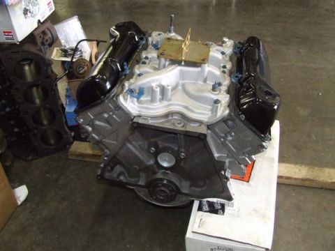 1979 Ford Bronco - Engine components are staged on a pallet, with a separate engine block visible to the left.