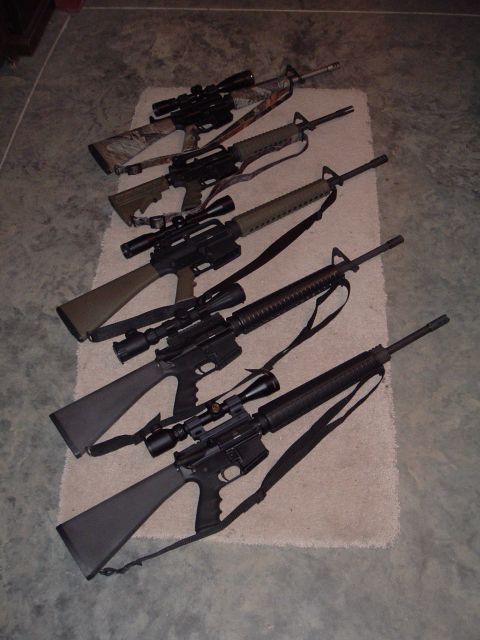 1995 Mercury Grand Marquis - Collection of rifles with scopes displayed on a rug.