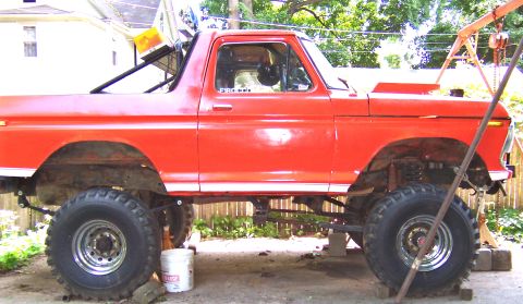 1978 Ford Bronco - This lifted 1978 Ford Bronco features a roll cage and is shown in profile, possibly undergoing modifications.