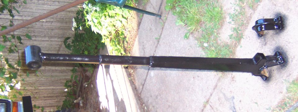 painted axle and bracket on ground