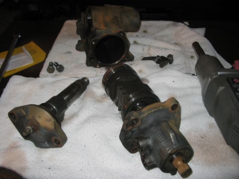 1991 Ford Bronco - Several metal parts, likely from a vehicle's steering system, are disassembled and spread out on a towel.