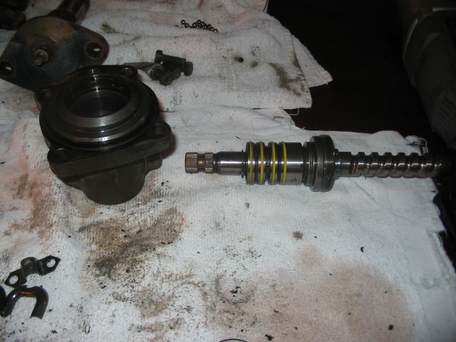Disassembled steering rack and pinion components on a white cloth