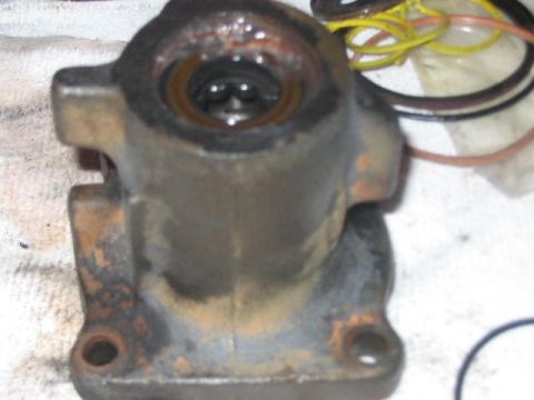 1991 Ford Bronco - Rusty hydroboost brake booster part with hoses visible in the background.