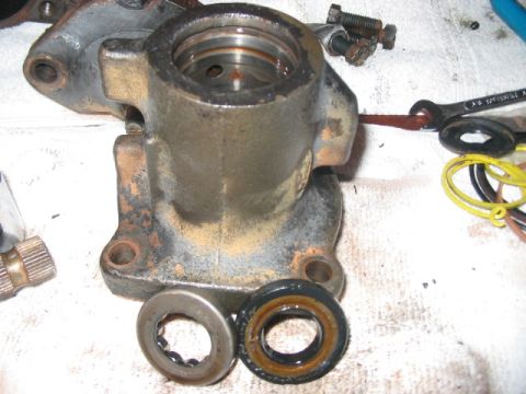 1991 Ford Bronco - A disassembled hydroboost brake booster assembly is shown with various seals and bearings laid out on a white cloth surface.