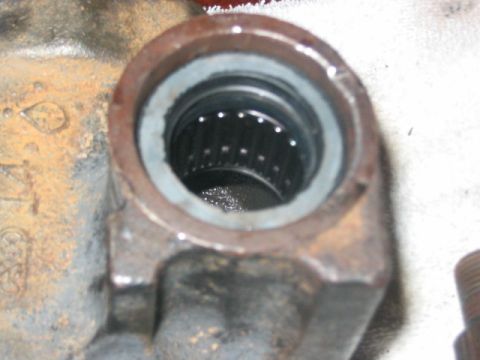 1991 Ford Bronco - Close-up of a rusty metal housing with a worn bearing inside.