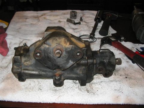 1991 Ford Bronco - Power steering gearbox removed from a vehicle, resting on a towel with tools nearby.