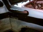 1990 Ford Ranger - Close-up view of the interior of a vehicle, with focus on a pipe and surrounding materials.
