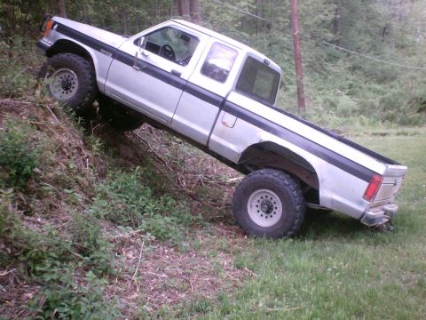 1990 Ford Ranger - This 1990 Ford Ranger is shown navigating a challenging incline off-road.