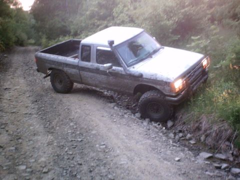 1990 Ford Ranger - This 1990 Ford Ranger is navigating a rough, unpaved trail through a wooded area.