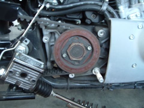 2002 Harley-Davidson Sportster Custom - Close-up view of a motorcycle's engine components, including the belt drive system and brake reservoir.