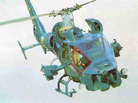 2007 Nissan Titan - Attack helicopter in flight, front 3/4 view. Pilot visible in cockpit.